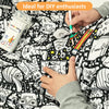 Person coloring a black and white illustration with markers on a large sheet of paper with similar designs.