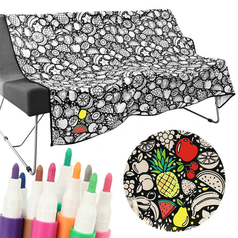 Black and white patterned towel with colorful markers and a round product with fruit design.